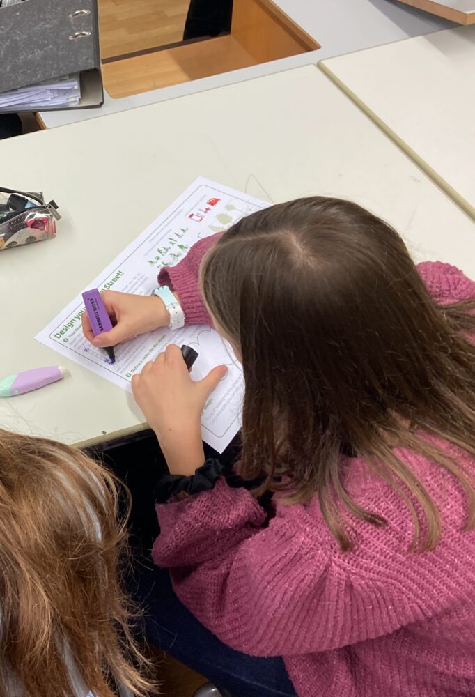 A pupil marking up a printed street worksheet