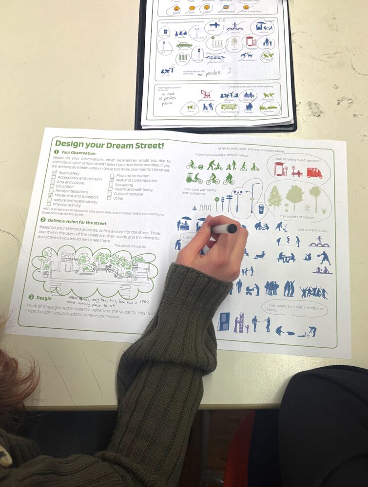 A pupil filling in the Design your Dream Street worksheet